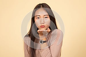 Beautiful young Asian woman blow a kiss