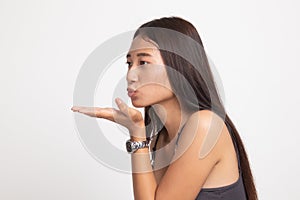Beautiful young Asian woman blow a kiss