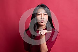 Beautiful young Asian woman blow a kiss