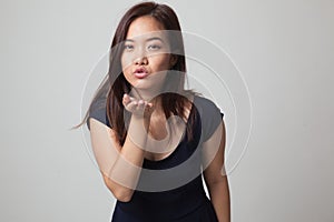 Beautiful young Asian woman blow a kiss.