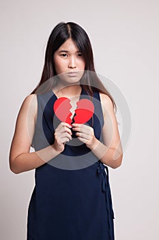 Beautiful young Asian woman with broken heart.