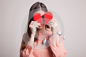 Beautiful young Asian woman with broken heart.