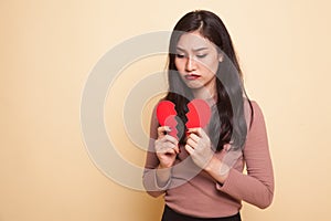 Beautiful young Asian woman with broken heart.