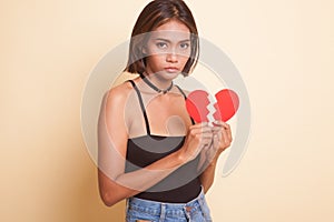 Beautiful young Asian woman with broken heart.