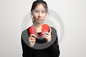 Beautiful young Asian woman with broken heart