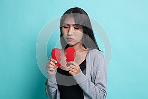 Beautiful young Asian woman with broken heart