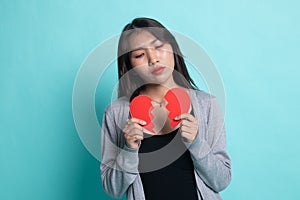 Beautiful young Asian woman with broken heart