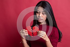 Beautiful young Asian woman with broken heart