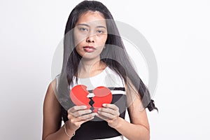 Beautiful young Asian woman with broken heart
