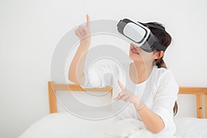 Beautiful young asian woman cheerful and fun wearing vr virtual reality headset