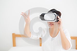 Beautiful young asian woman cheerful and fun wearing vr virtual reality headset, girl device and watching simulator game