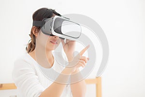 Beautiful young asian woman cheerful and fun wearing vr virtual reality headset, girl device and watching simulator game