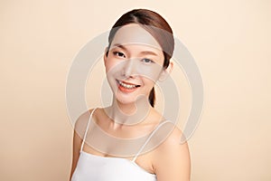 Beautiful young asian woman with clean fresh skin on beige background, Face care, Facial treatment, Cosmetology, beauty and spa,