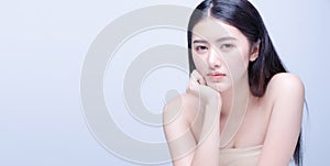 Beautiful Young asian Woman with Clean Fresh Skin look at camera. Girl beauty face care. Facial treatment. Cosmetology, beauty and