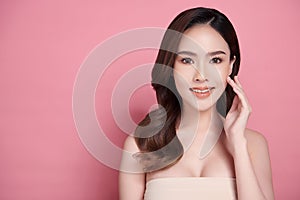 Beautiful young asian woman with clean fresh skin on pink background, Face care, Facial treatment, Cosmetology, beauty and spa,