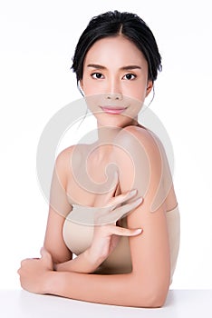 Beautiful Young Asian Woman hand Touching on Shoulder. Clean and Fresh skin, on white background, Beauty Cosmetology Concept