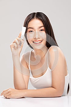 Beautiful Young Asian Woman Holding luxury white clean tube smile
