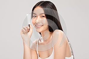Beautiful Young Asian Woman Holding luxury white clean tube smile feeling so happy