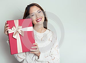 Beautiful young asian woman holding a present