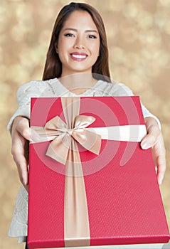 Beautiful young asian woman holding a present