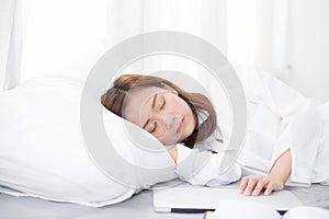 Beautiful young asian woman with laptop lying down in bedroom, girl tired sleep with computer notebook.