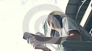 Beautiful young asian woman listening to music on a smart phone in the city. Young asian woman relaxing listening to music.