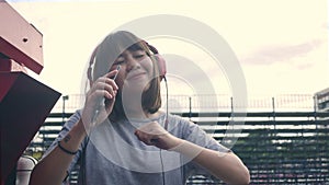 Beautiful young asian woman listening to music on a smart phone in the city. Young asian woman relaxing listening to music.