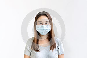 Beautiful young Asian woman with protective face mask on white background. New normal, health care concept