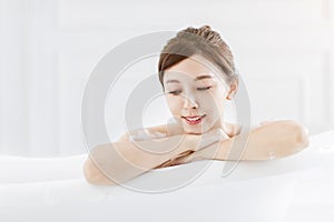 Beautiful young asian woman relaxing in bathtub