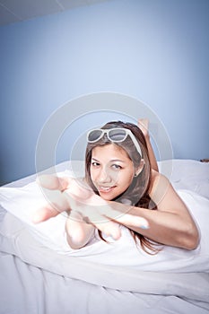 Beautiful young Asian woman relaxing on the bed