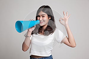 Beautiful young Asian woman show OK announce with megaphone.