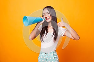 Beautiful young Asian woman show thumbs up announce with megaphone.