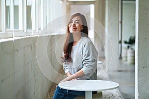 A beautiful young asian woman sitting in cafe with feeling happy