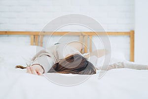 Beautiful young Asian woman sleeping in bed in the morning. Attractive asian girl use bedtime in her comfortable bedroom.