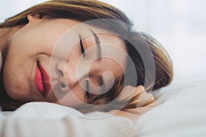 Beautiful young Asian woman sleeping in bed in the morning. Attractive asian girl use bedtime in her comfortable bedroom.