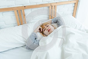 Beautiful young Asian woman sleeping in bed in the morning. Attractive asian girl use bedtime in her comfortable bedroom.