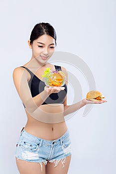 Beautiful young asian woman slim shape with diet choosing fresh salad vegetable and hamburger isolated