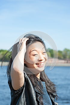 Beautiful young asian woman smiling in the city at sunny day