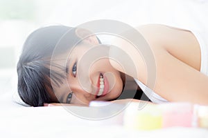 Beautiful of young asian woman smiling and lying on bed at bedroom, beauty of girl with hygiene and healthy.