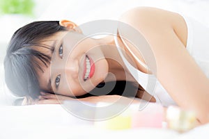 Beautiful of young asian woman smiling and lying on bed at bedroom, beauty of girl with hygiene and healthy.