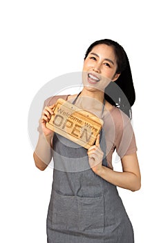 Beautiful young asian woman smiling pretty teeth wearing a apron.Woman holding a wooden sign pointing and thumbs up