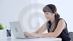 Beautiful young asian woman smiling say hello using chat social network with video call on laptop computer