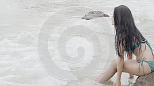 Beautiful young asian woman splash water with hand in seaside, girl in bikini sexy leisure in vacation on the beach.