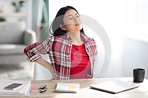 Beautiful Young Asian Woman Suffering From Backache While Working In Home Office