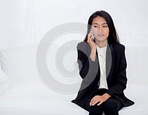 Beautiful young asian woman talking phone and smile in the living room