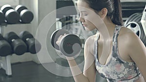 Beautiful young asian woman training workout with strong at gym, asia girl bodyweight with lifting dumbbell at fitness
