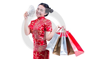 Beautiful Young asian woman wear chinese dress traditional cheongsam or qipao with Carrying a shopping bag and dollar banknote