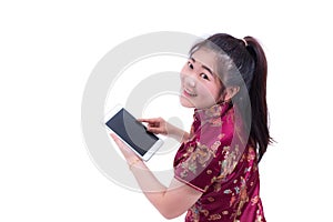 Beautiful Young asian woman wear chinese dress traditional cheongsam or qipao. Hand holding blank screen digital tablet