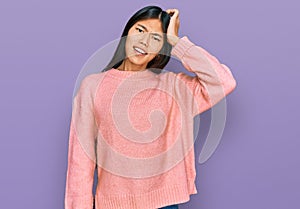 Beautiful young asian woman wearing casual winter sweater confuse and wonder about question