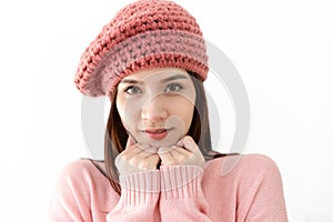 Beautiful young Asian woman wearing knitted sweater pink cold and  keeping hands on chin looking at camera with isolated on white
